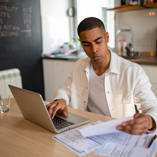 Man on laptop doing financial projections